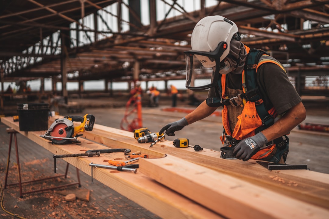 Contractor measuring lumber on a Hardin County job site