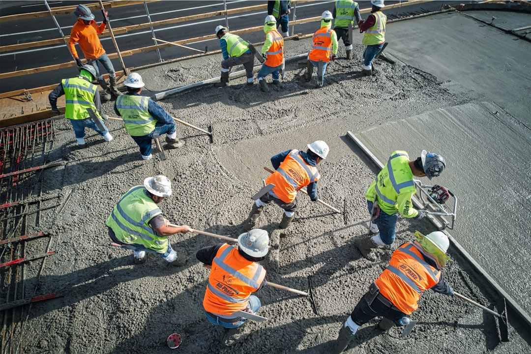 Crew finishing a fresh concrete slab